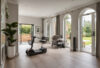 Elegant open-plan living room with step-free access and a mobility scooter parked by the wall